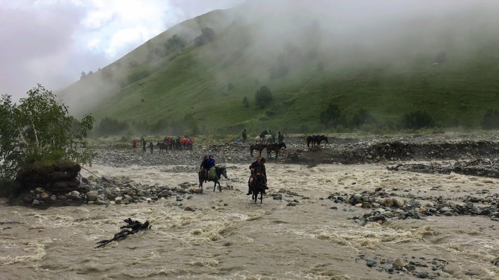 Crossing Adishi river on horse